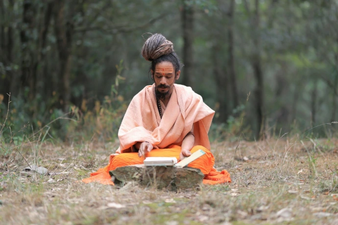 A person sitting in the middle of a forest